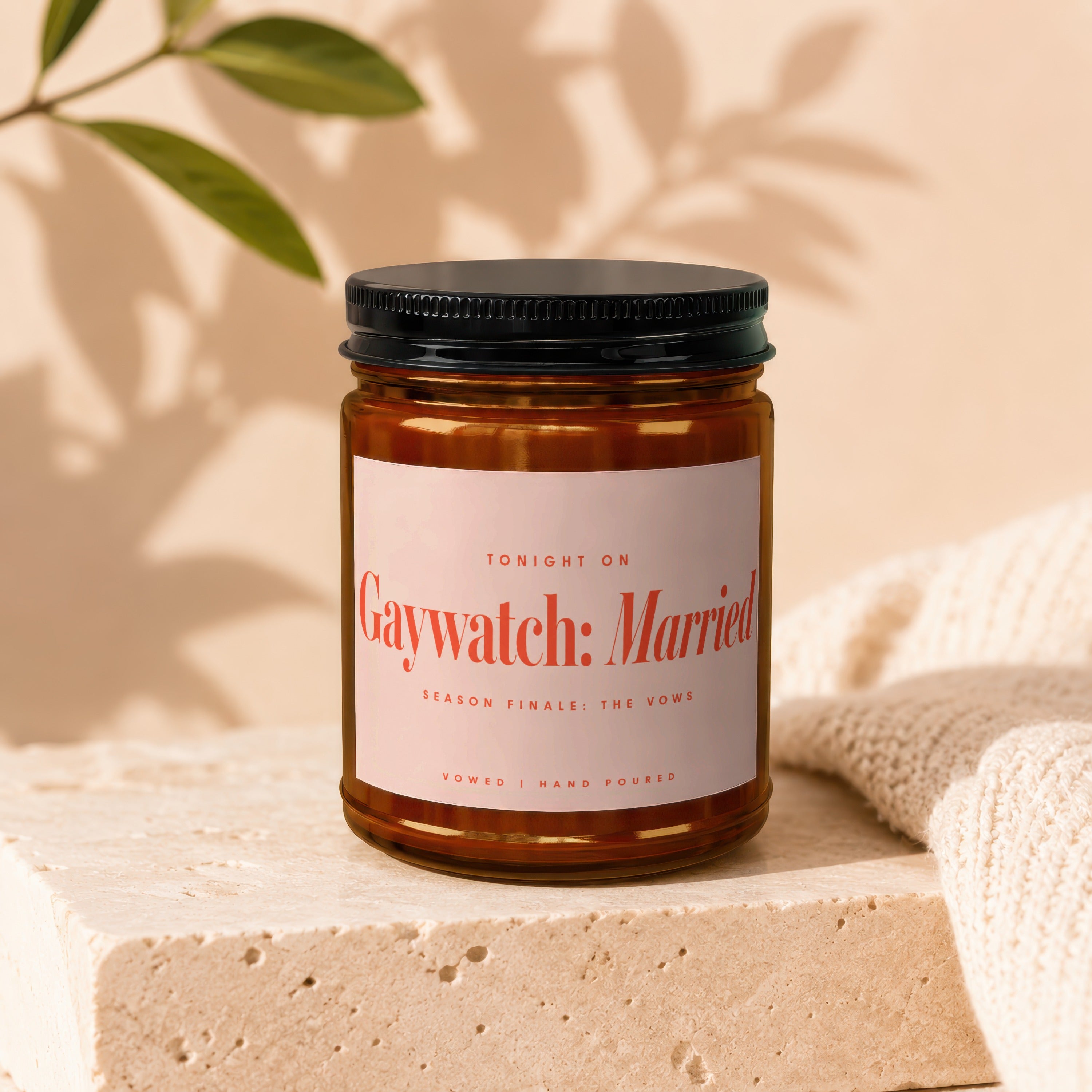 Amber candle with pink label that says "Gaywatch: Married Season Finale: The Vows."