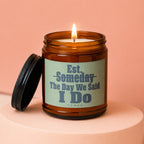Candle with text "Est. Someday The Day We Said I Do" in amber jar.