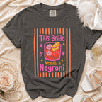 T-shirt with text "This Bride Needs a Negroni" and cocktail graphic.