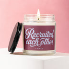 Candle with label saying "Recruited each other VOWED" with lid off.