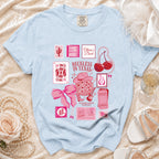 Light blue t-shirt with "Olivia's Bach" and Texas-themed graphics.