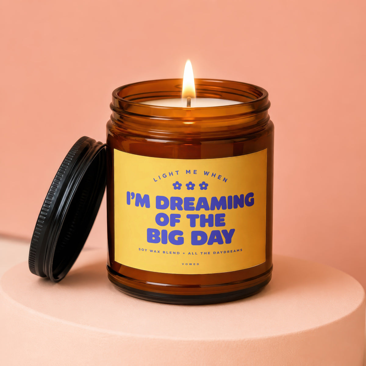 Brown glass candle with lit wick and black lid. Label reads "I'm Dreaming of the Big Day".