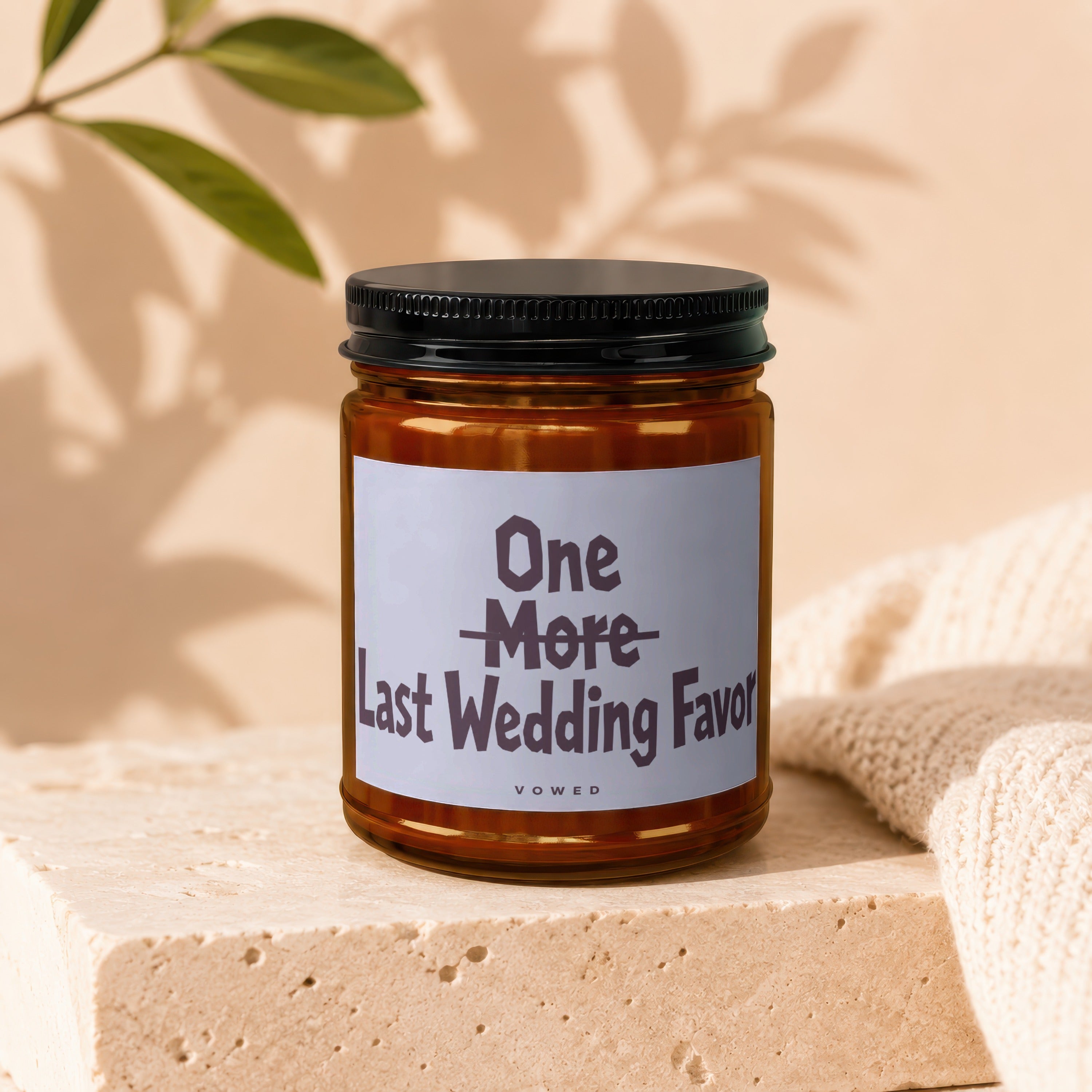 Amber jar candle with black lid, label reads "One More Last Wedding Favor".