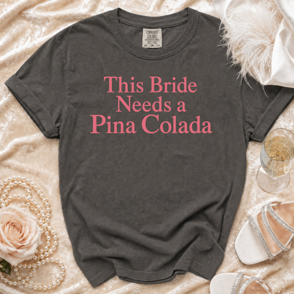 Grey t-shirt with "This Bride Needs a Pina Colada" text in pink.