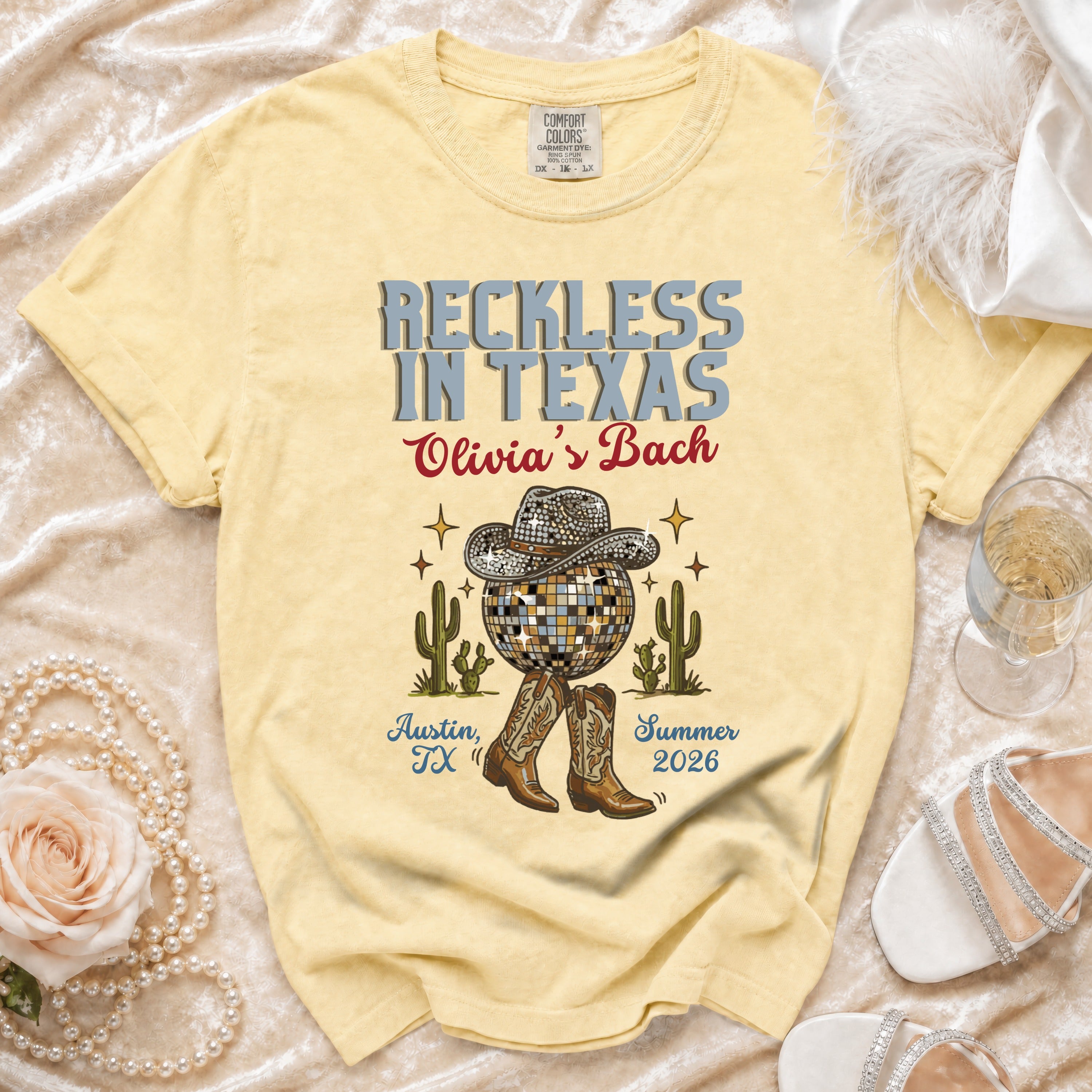 Yellow t-shirt with "Reckless in Texas Olivia's Bach" design.