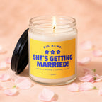 Candle with yellow label reading "BIG NEWS: SHE'S GETTING MARRIED!"