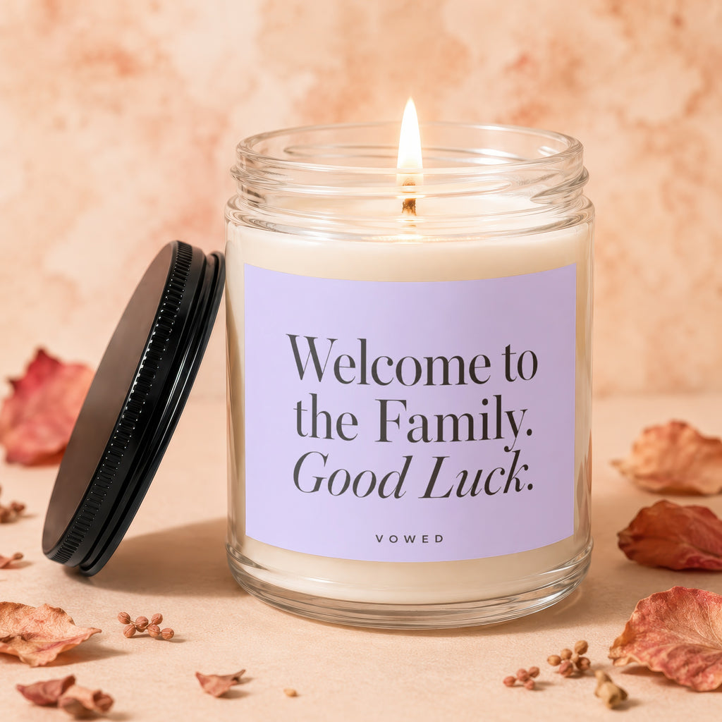 Candle with "Welcome to the Family. Good Luck." text on a lavender label.
