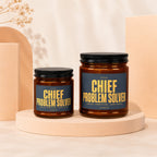 Two amber jars with black lids feature labels reading "Chief Problem Solver".