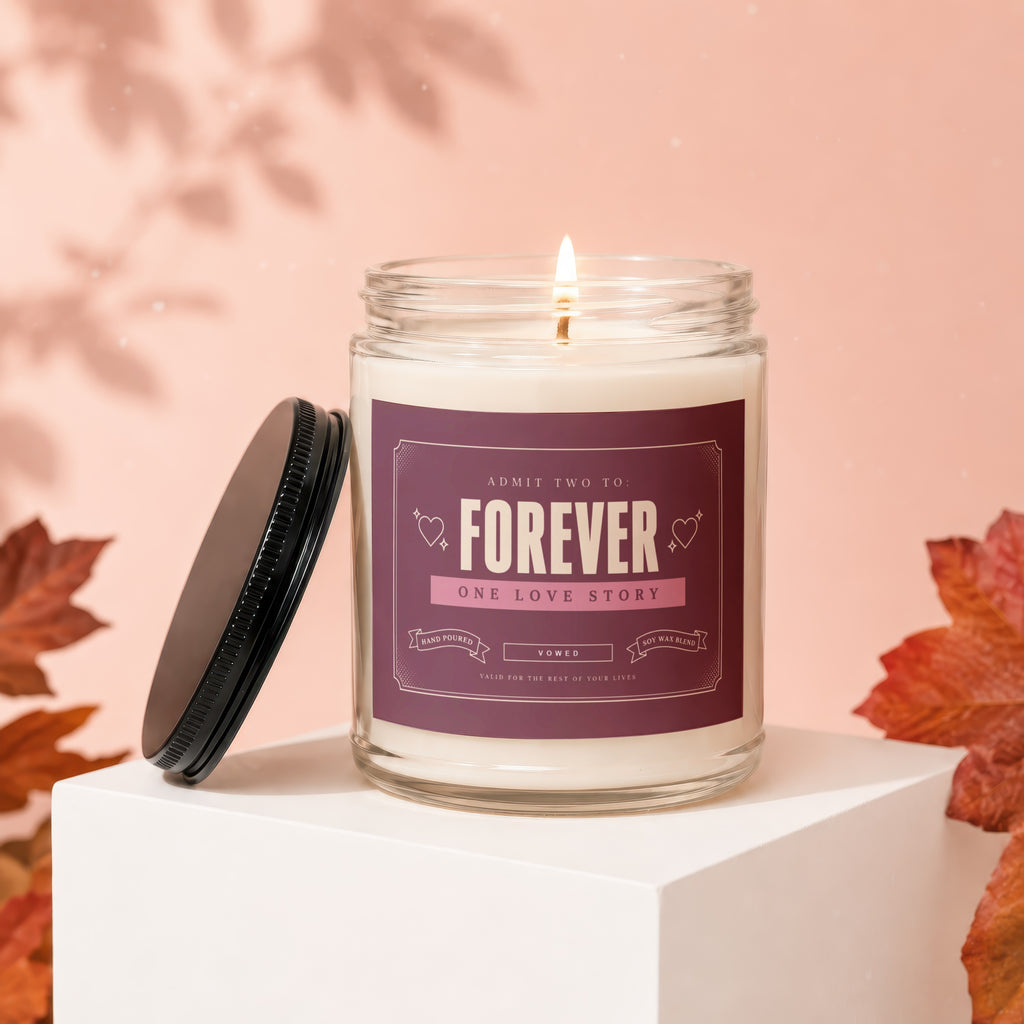 Lit candle with "Forever One Love Story Vowed" label on pink background with autumn leaves.