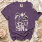 Purple t-shirt with "Something Wicked Said I Do" text and gothic wedding graphics.