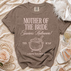 Brown Comfort Colors t-shirt with "Mother of the Bride Survives Halloween!" and cauldron graphic.