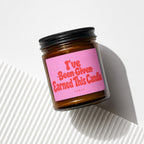 Amber jar candle with a pink label reading "I've Been Given Earned This Candle."
