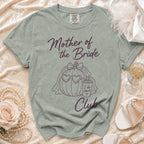 Light green t-shirt with "Mother of the Bride" and "Club" text and pumpkin graphic.