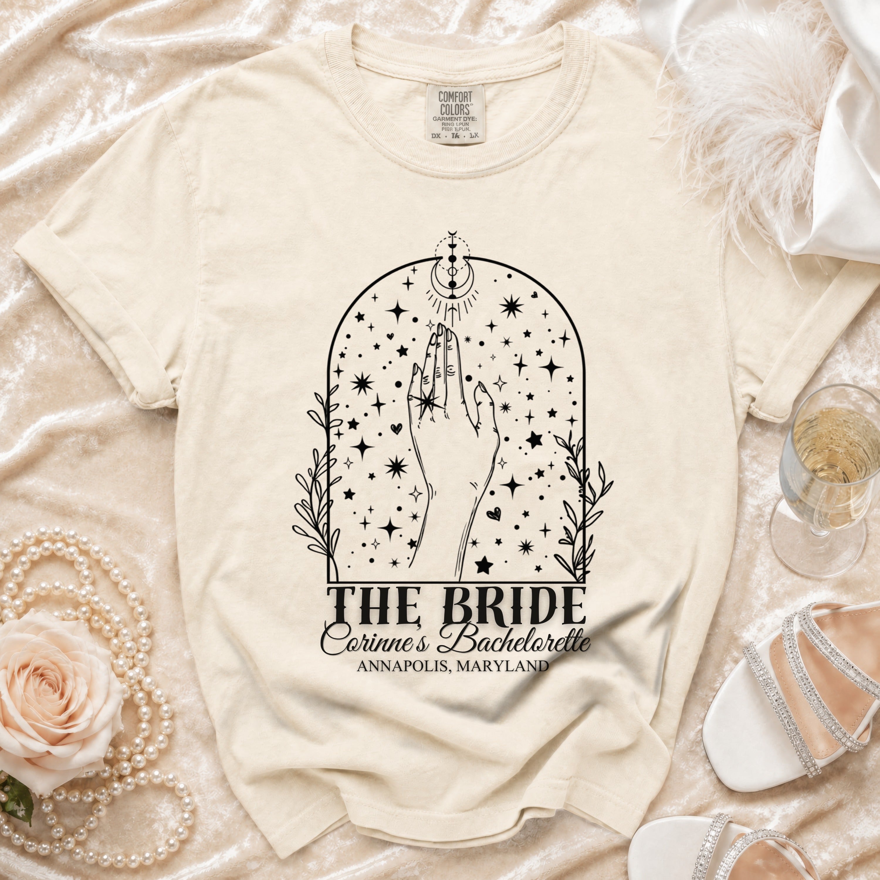 Cream t-shirt with "The Bride Corinne's Bachelorette" graphic.