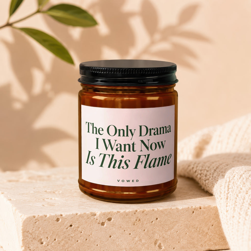 Amber candle with black lid, reads "The Only Drama I Want Now Is This Flame VOWED".
