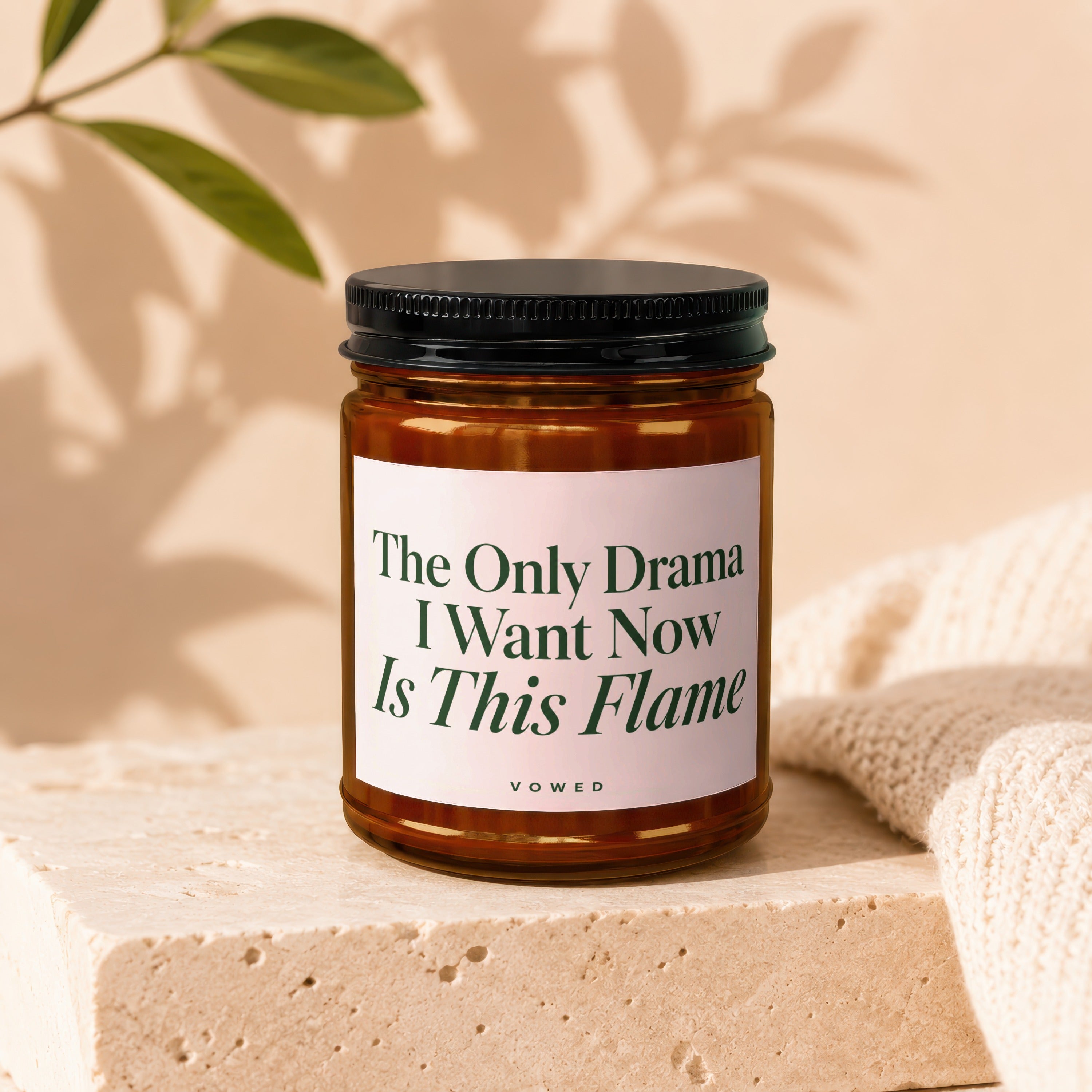 Amber candle with black lid, reads "The Only Drama I Want Now Is This Flame VOWED".
