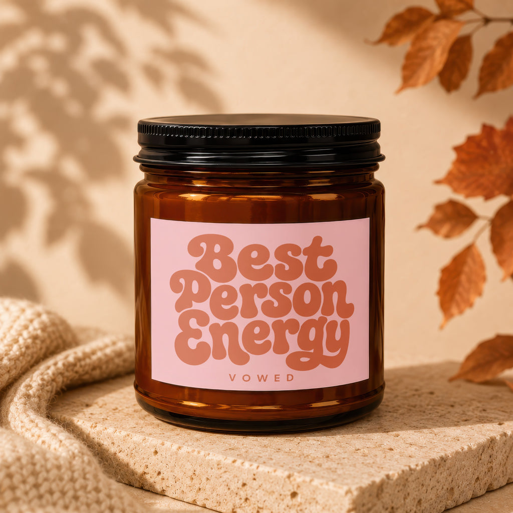 Brown candle with pink label reading "Best Person Energy" and "VOWED".