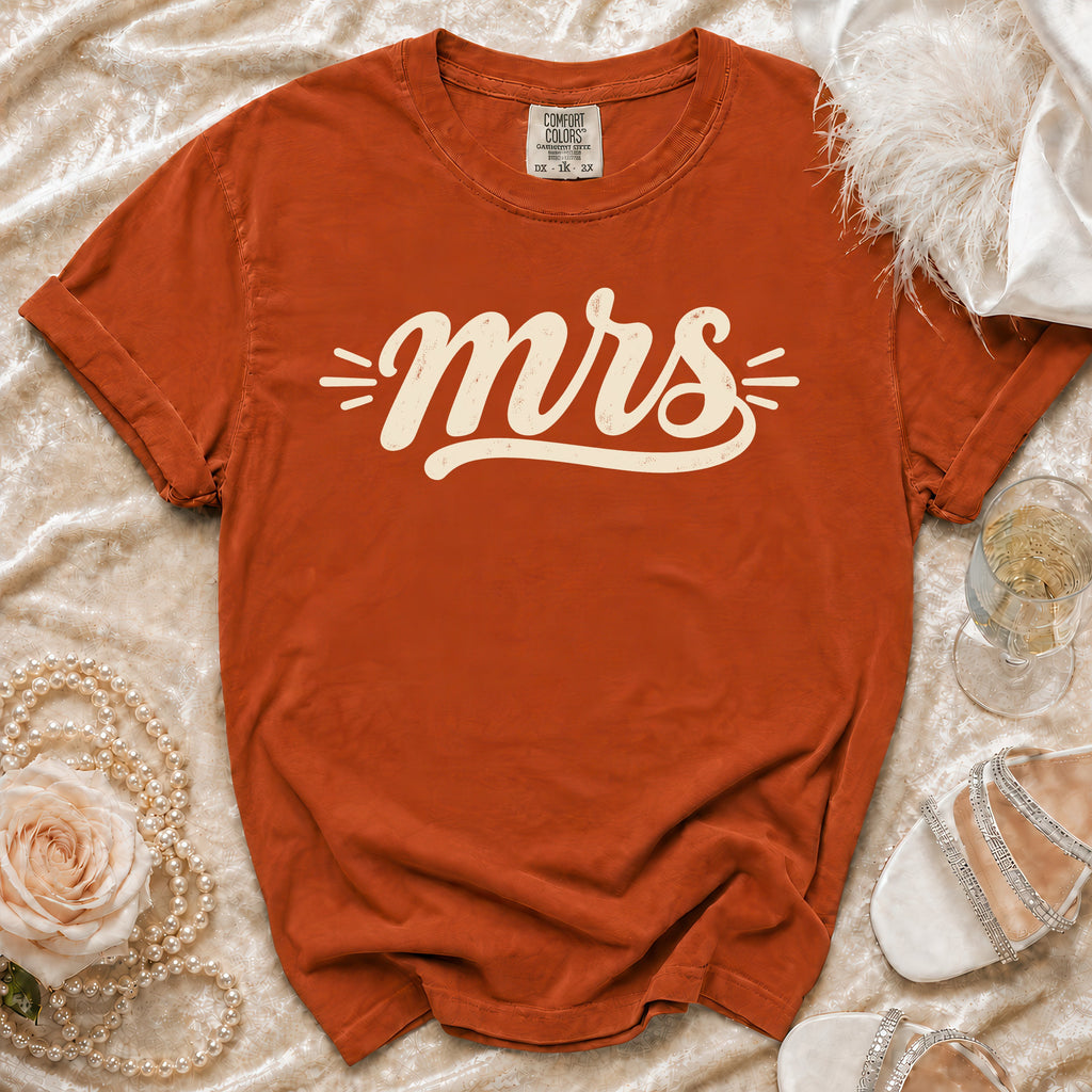 Orange Comfort Colors t-shirt with "mrs" graphic and decorative elements.