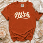 Orange Comfort Colors t-shirt with "mrs" graphic and decorative elements.