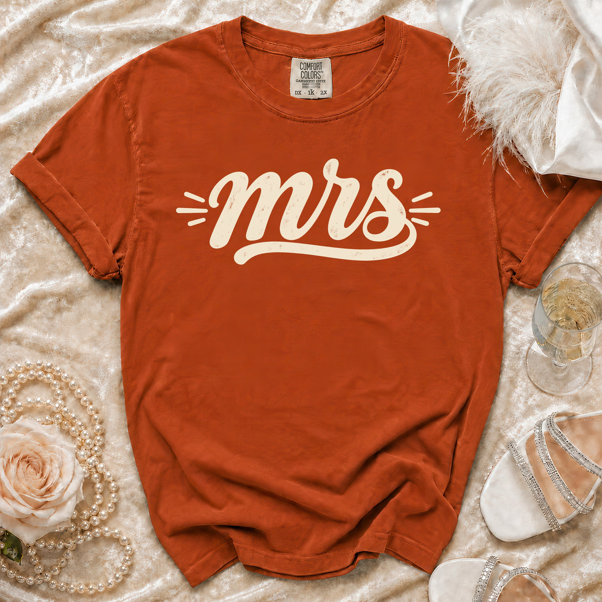 Orange Comfort Colors t-shirt with "mrs" graphic and decorative elements.