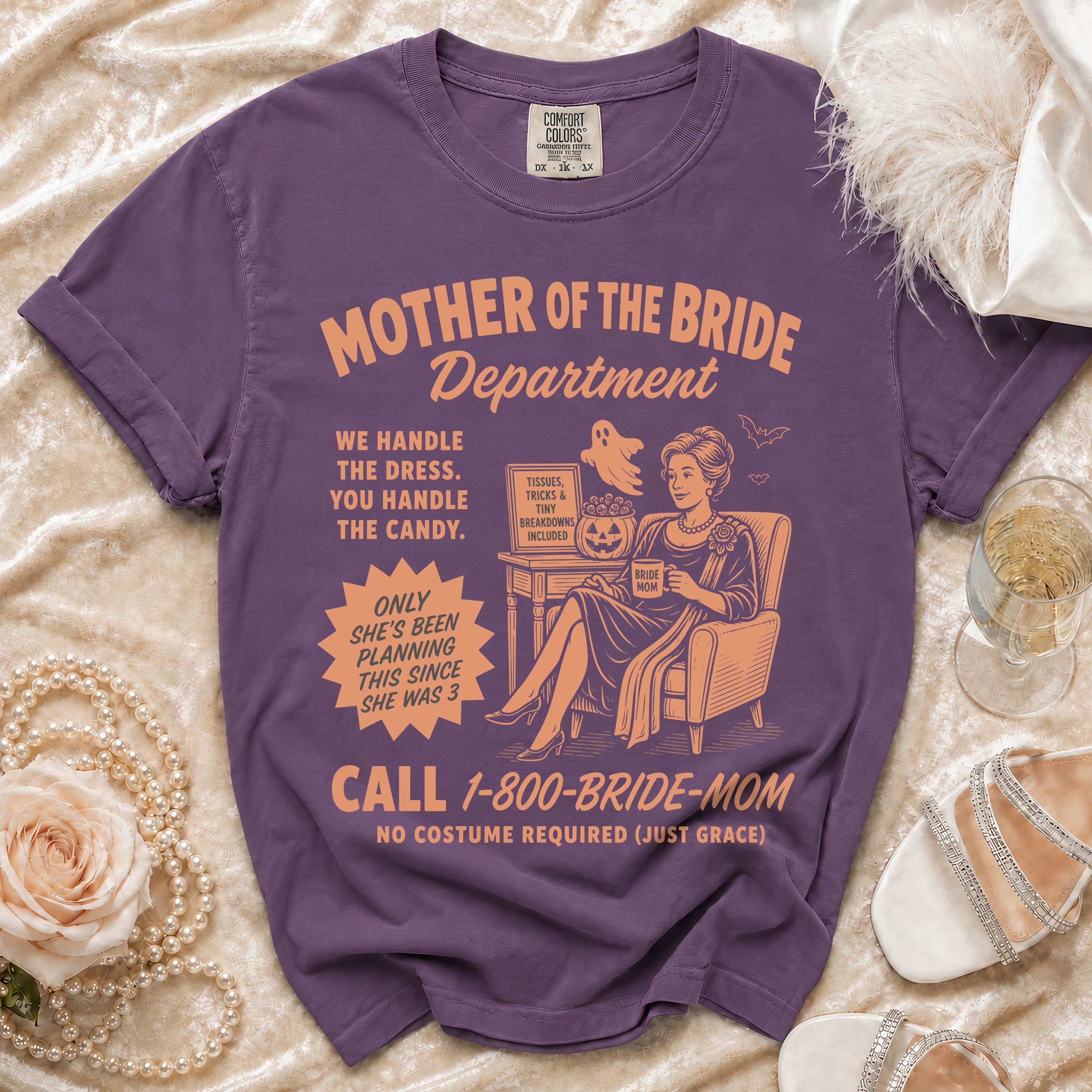 Purple t-shirt with "Mother of the Bride Department" graphic and humorous text.