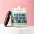 Candle with text "OCCASIONAL PROFESSIONAL VEIL UNTANGLER VOWED" on a light green label.