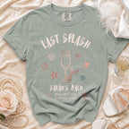 "Last Splash Sarah's Bach" text on a sage green t-shirt with seashells.