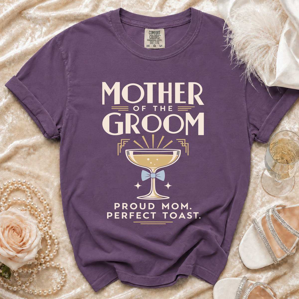 Purple t-shirt with "Mother of the Groom" and champagne glass graphic.