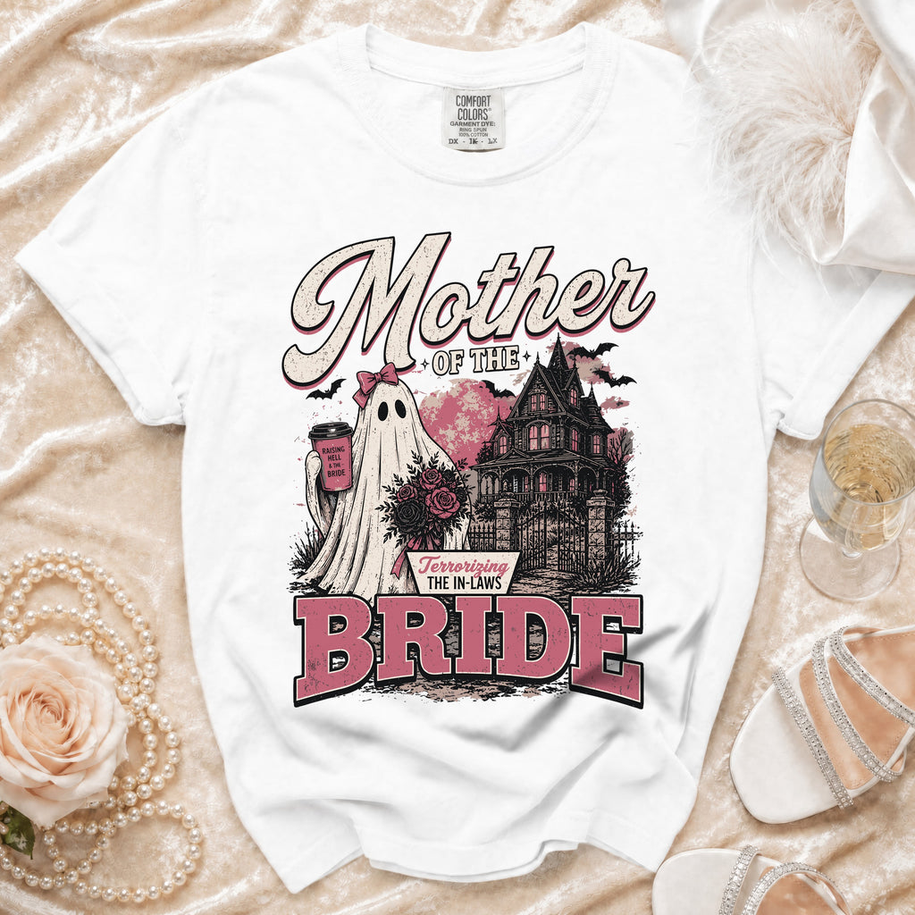 White t-shirt with "Mother of the Bride" text and a ghost bride near a haunted house.