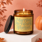 Amber jar candle, lit, with "Marrying My Favorite Human" text.