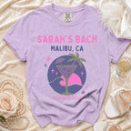 T-shirt graphic: "Sarah's Bach Malibu, CA Summer 2026" with cocktail.