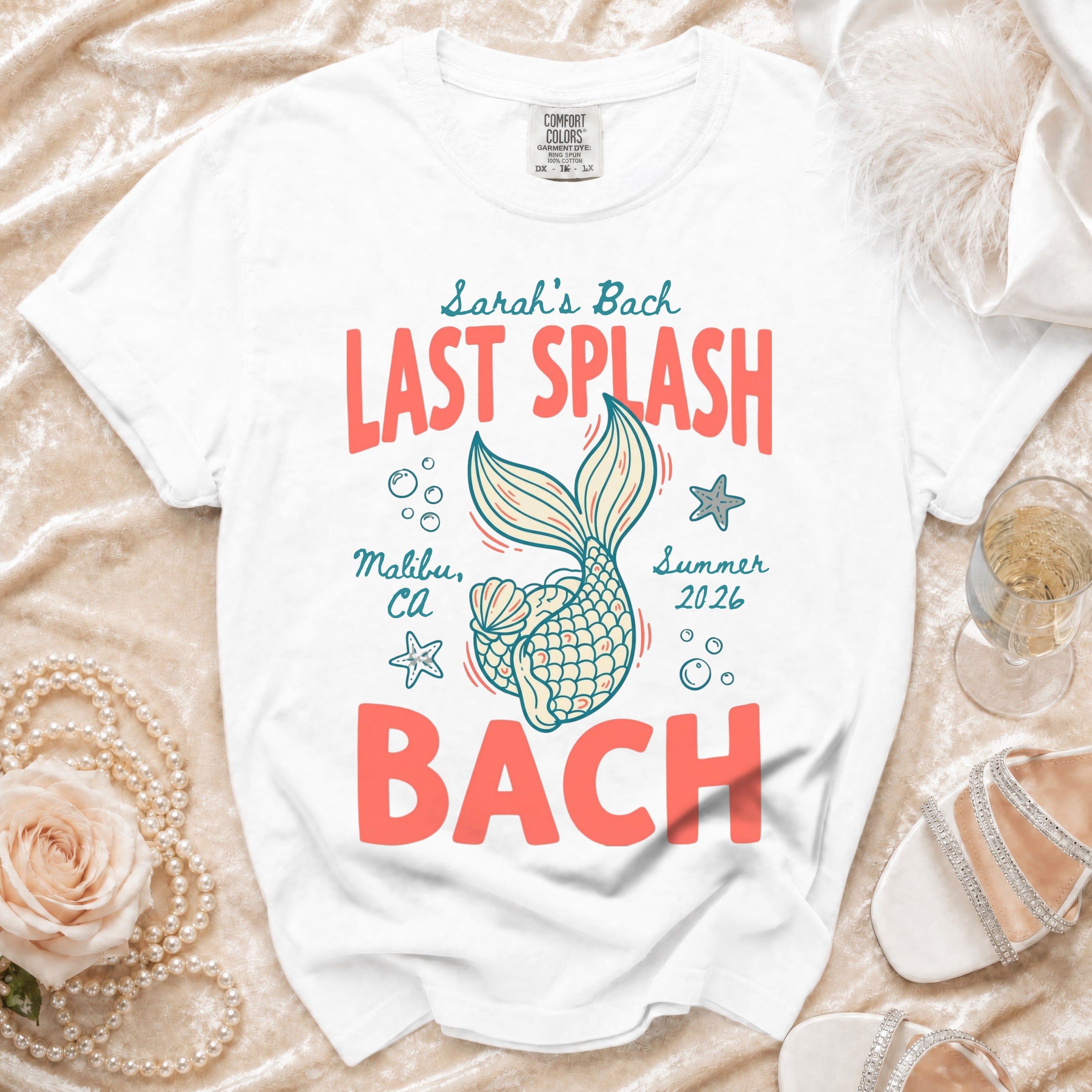 White t-shirt with "Last Splash Bach" in coral text, mermaid tail.