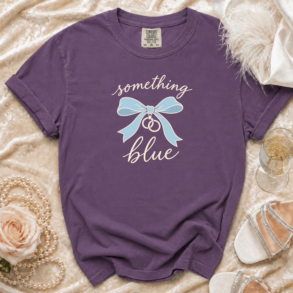 Purple t-shirt with "something blue" text, a bow, and wedding rings graphic.