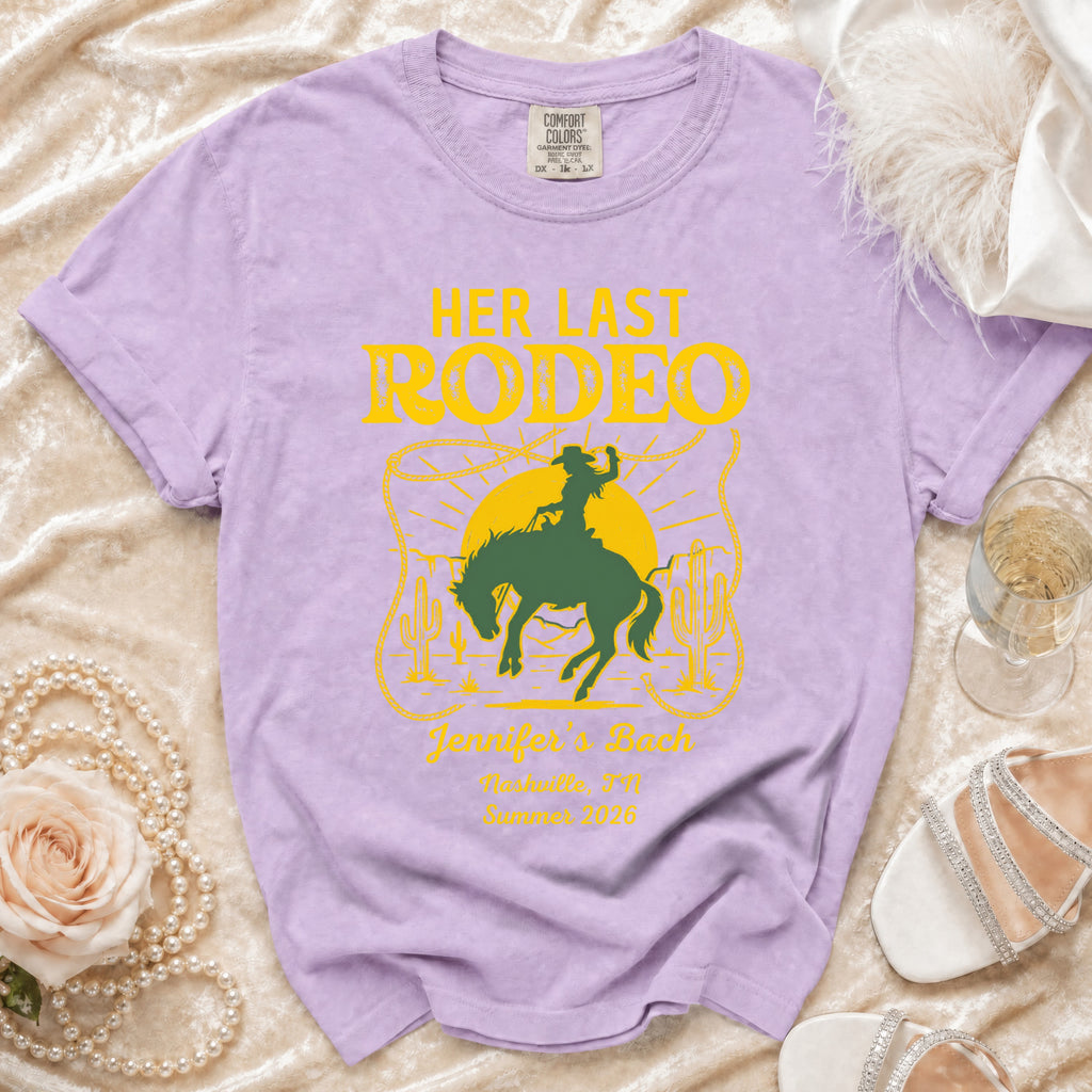 Lavender t-shirt with "Her Last Rodeo" graphic, rodeo scene, and event details.