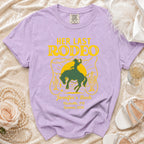 Lavender t-shirt with "Her Last Rodeo" graphic, rodeo scene, and event details.