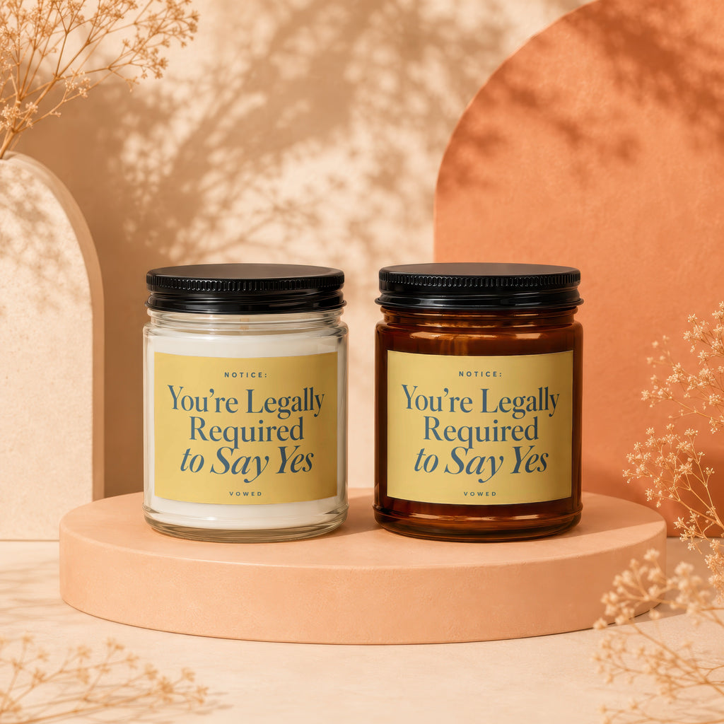 Two candles with black lids, labels reading "You're Legally Required to Say Yes."