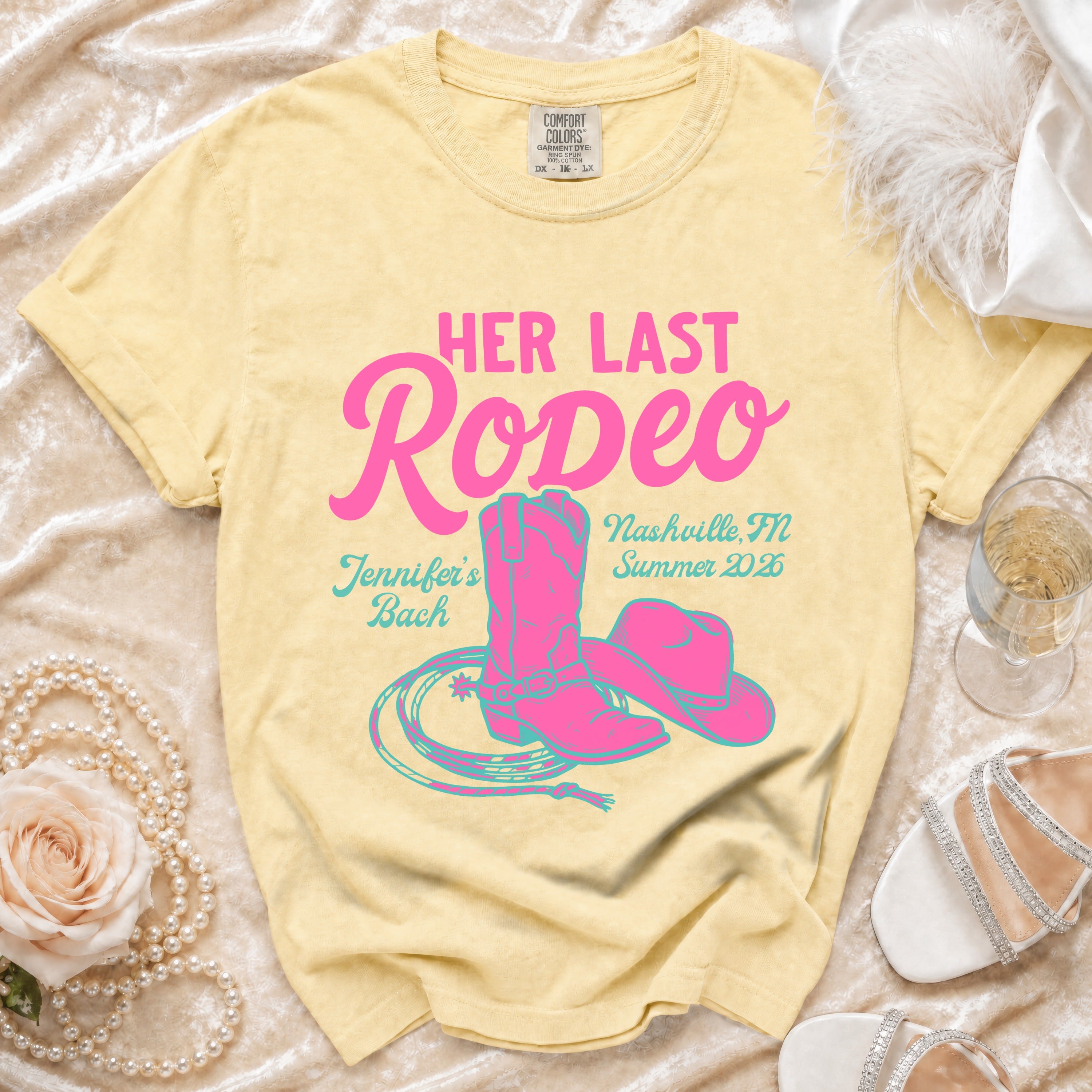 Yellow t-shirt with "Her Last Rodeo" in pink, cowgirl boots, hat, and rope.