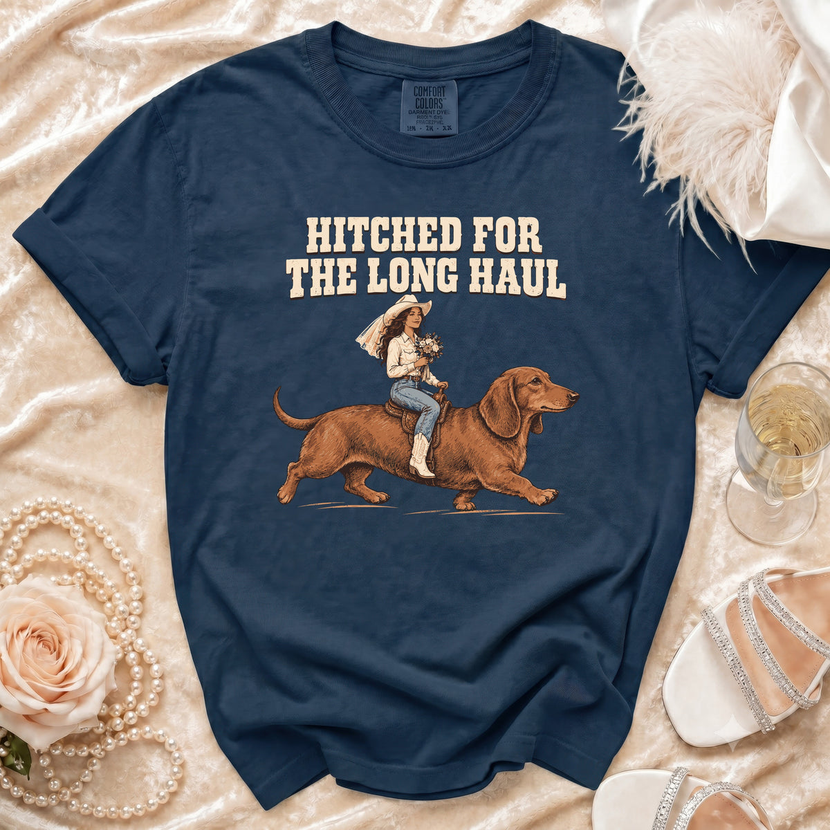 Navy t-shirt with "Hitched for the long haul" and bride riding dachshund graphic.