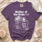 Purple t-shirt with "Mother of the Bride Club" and skull graphic.