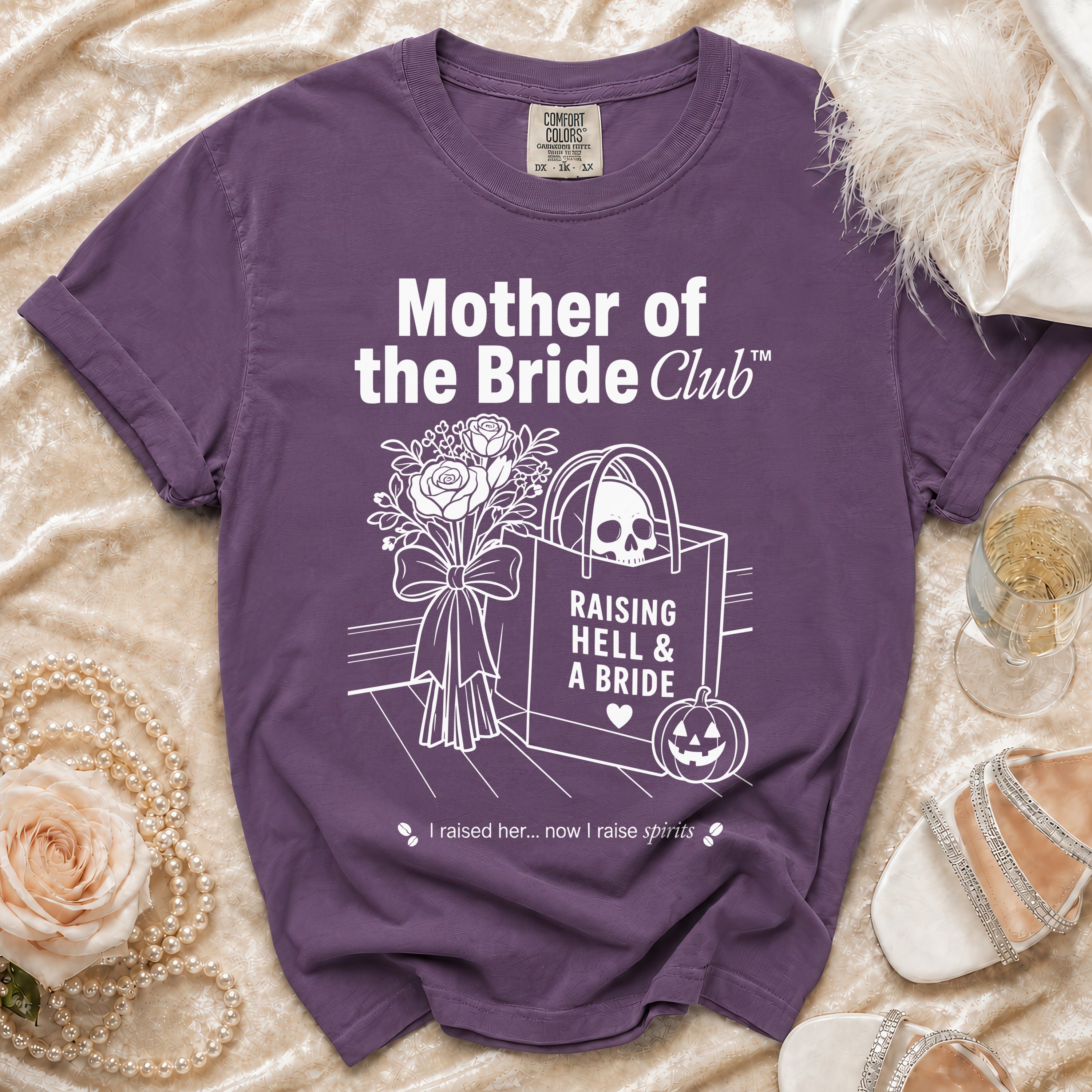Purple t-shirt with "Mother of the Bride Club" and skull graphic.