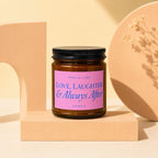Brown candle with pink label that reads "Smells Like Love, Laughter & Always After Vowed".