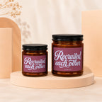 Two amber jars with black lids, labeled "Recruited each other".