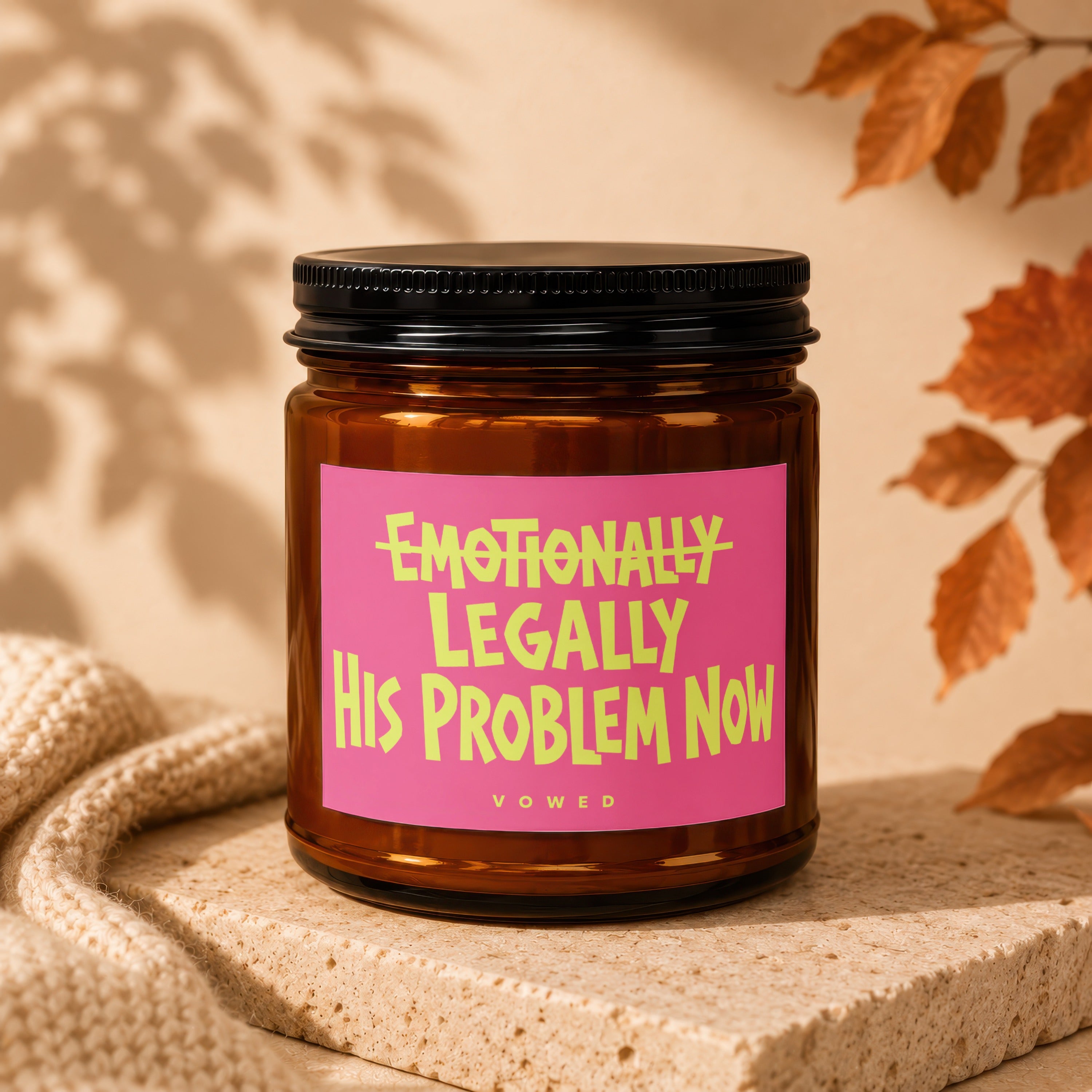 Amber candle with a pink label that reads "emotionally legally his problem now".