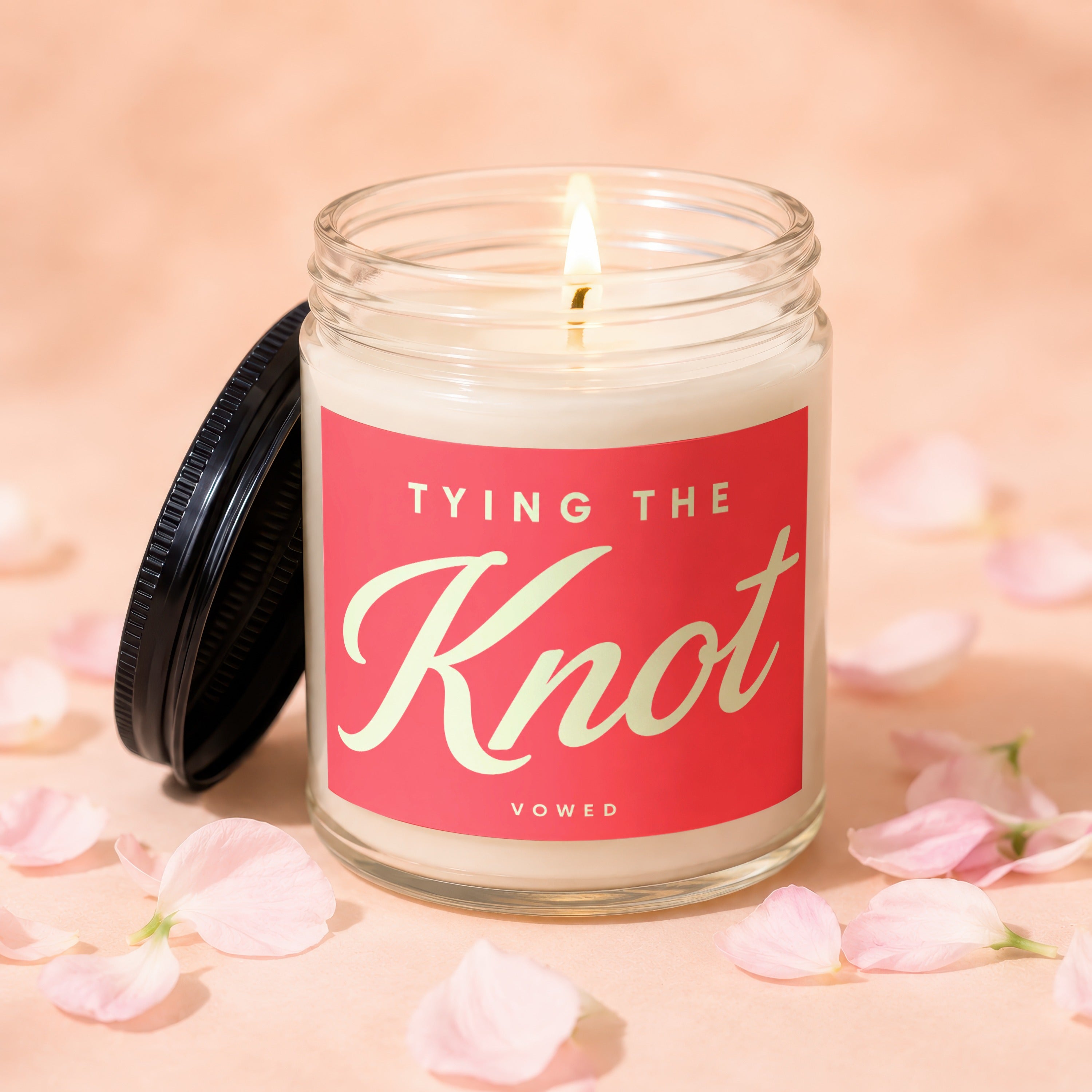 Glass candle with "TYING THE Knot" and "VOWED" on red label.