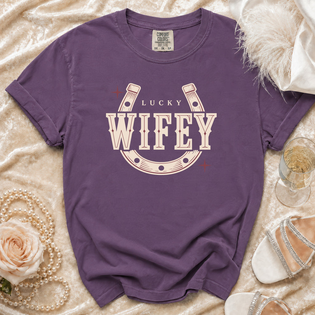 Purple t-shirt with "Lucky Wifey" text inside a horseshoe graphic.