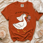 Orange t-shirt with graphic of goose in wedding veil holding flowers, text "off to get married".