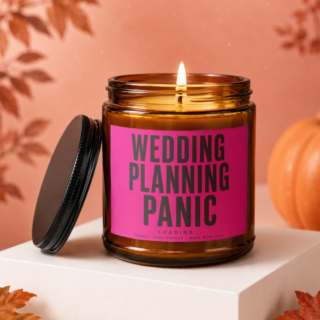 Amber jar candle with pink label reading "WEDDING PLANNING PANIC LOADING..."