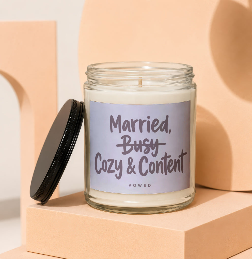 Candle with text "Married, Cozy & Content" and "VOWED" on label