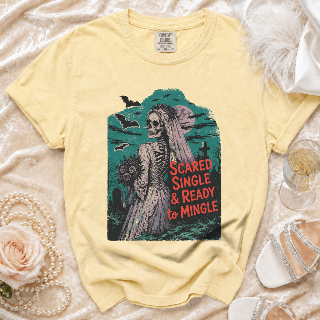 Yellow t-shirt with a skeleton bride graphic and text "Scared Single & Ready to Mingle".