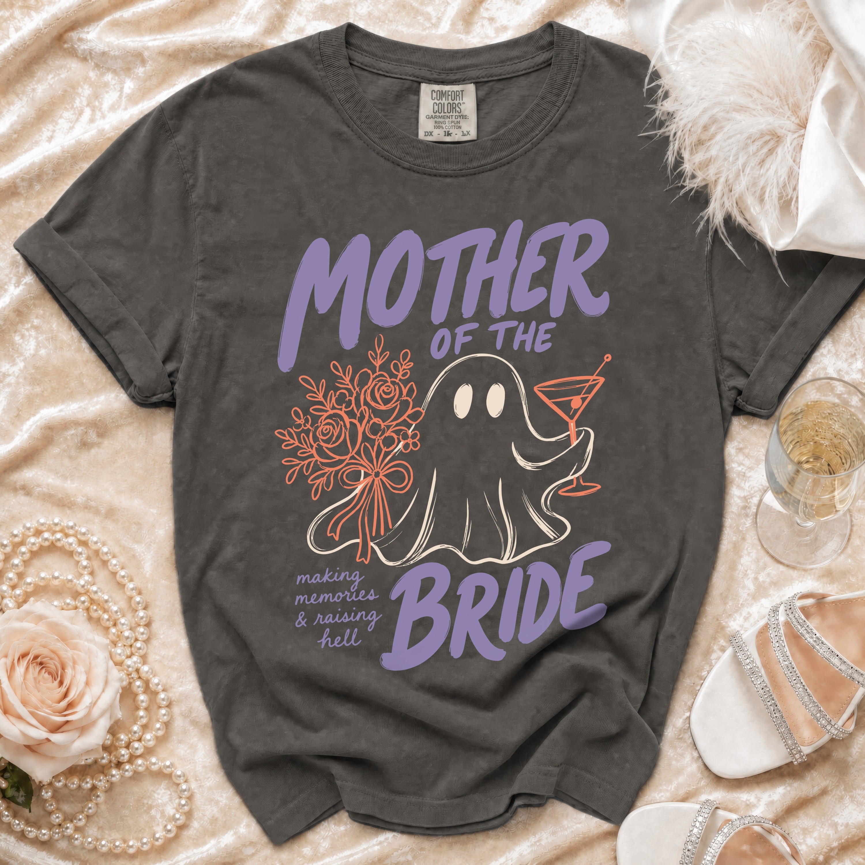 Grey t-shirt with "Mother of the Bride" ghost graphic and floral accents.